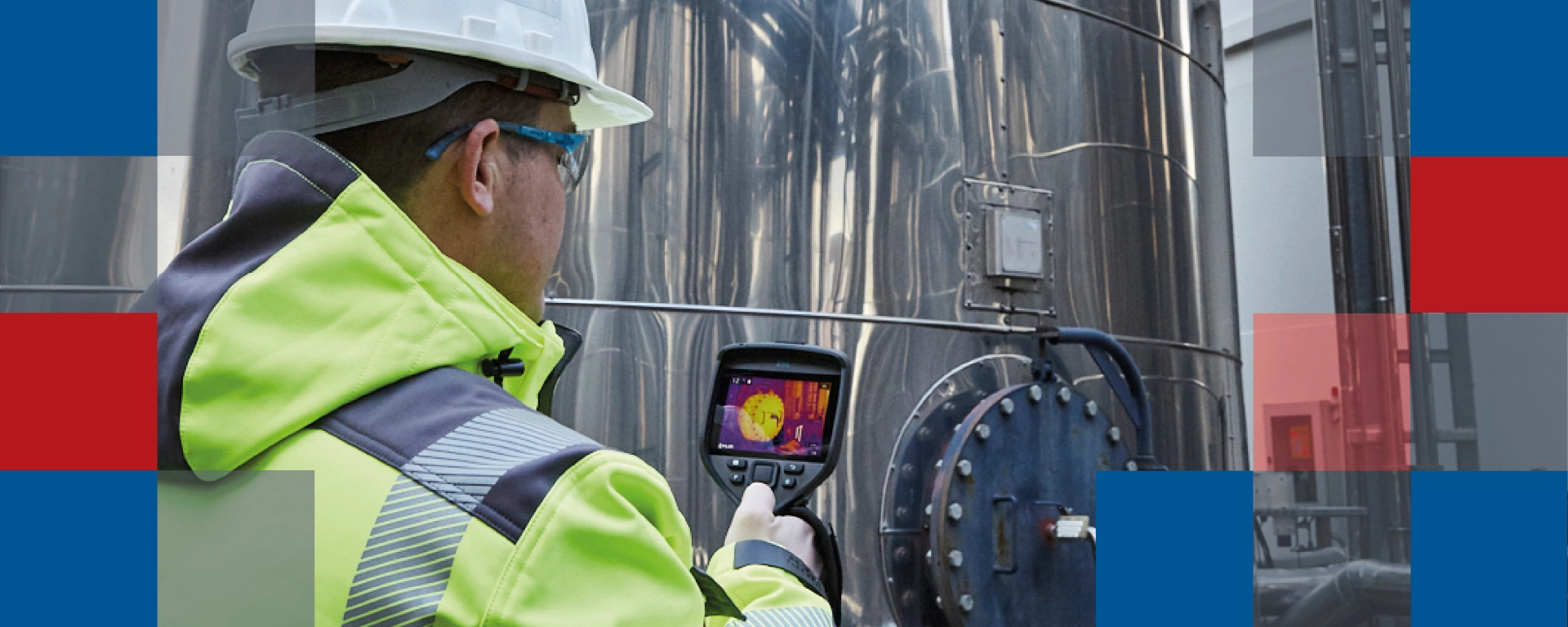 A man examining an industrial tank with a thermal imaging camera 