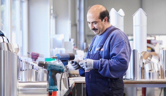 An insulation specialist working on insulated panels at his workbench