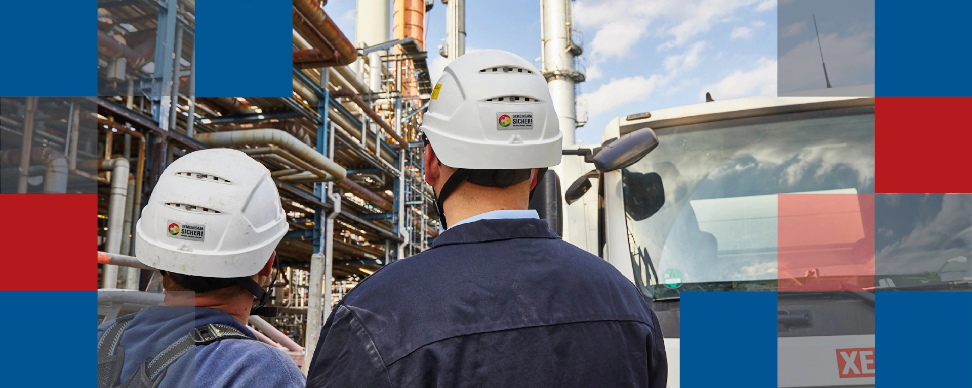 Two men looking at an industrial site in the background